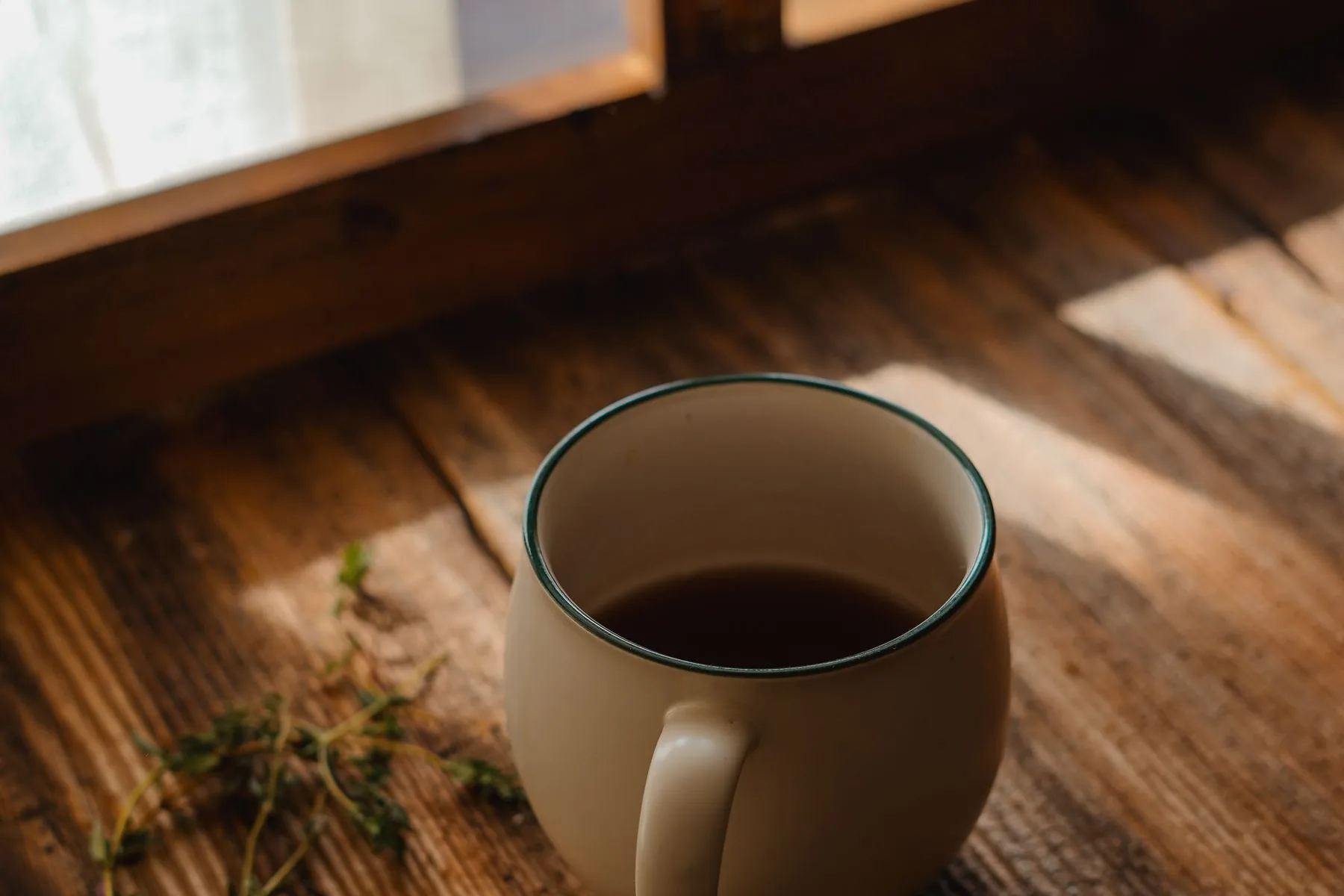 A quiet coffee mug on a sunlit windowsill, the morning after