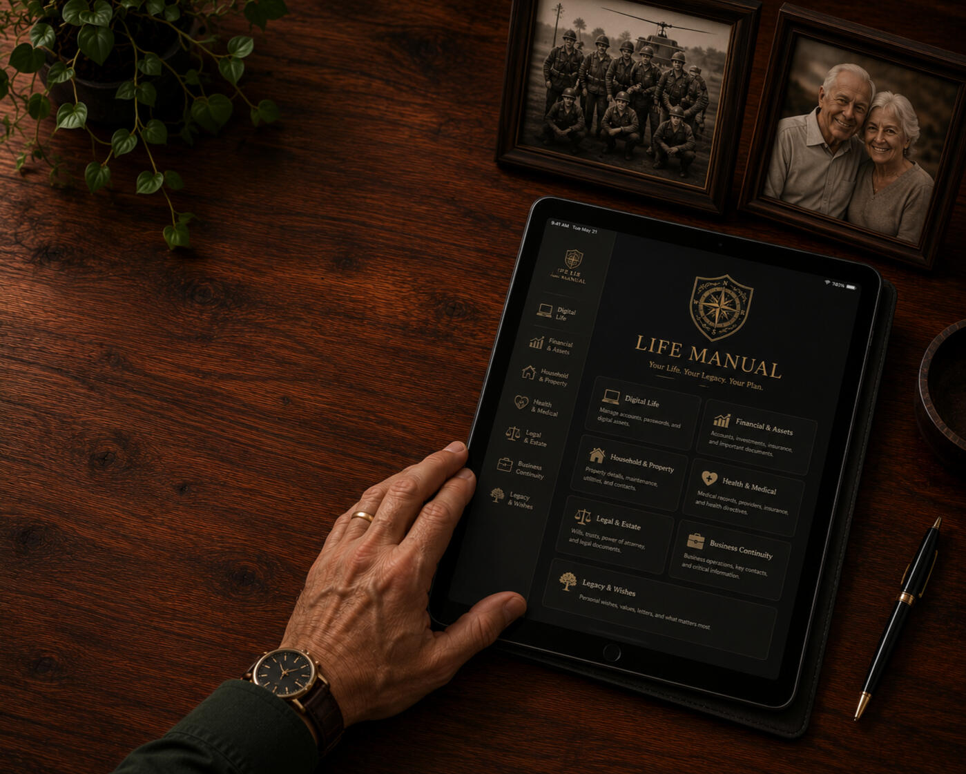 Tablet displaying a Life Manual beside framed family photos on a wooden desk, representing organized information someone else could use if needed.